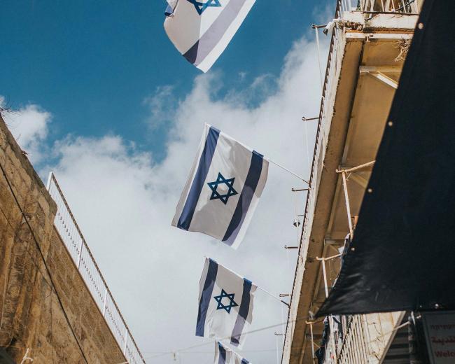 Photo of Israeli flags. Would you like to volunteer in Israel?
